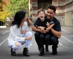 Outdoor Casual Family Portrait of two parents with young son in