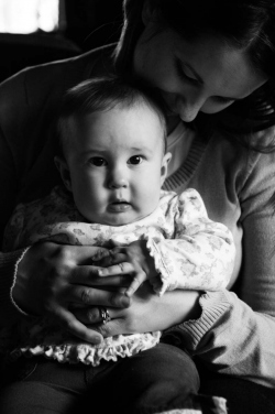 Black and White portraif of an infant daughter sitting on her mo