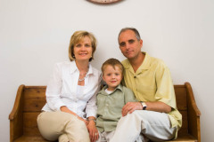 In home Family Portrait of mother, father and young boy sitting