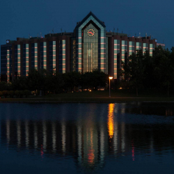 Clock at dusk at Hilton Suites and reflecton in pool of water fr