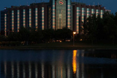 Clock at dusk at Hilton Suites and reflecton in pool of water fr