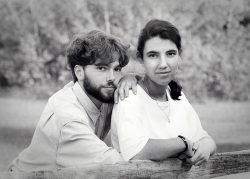 Young Couple Leaning on Split Cedar Rail Fence as Photographed f